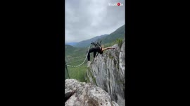 Epic rope-jumping stunt sees brave young woman doing a backflip off a huge cliff