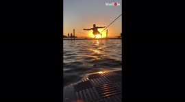 'Nature lover bravely walks a slackline above water at sunset *Visually Soothing*'