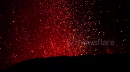 Lava spewed out by Mount Etna illuminates night sky in Sicily