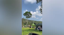 Strong wind blows tourists' tents away in campsite in Thailand