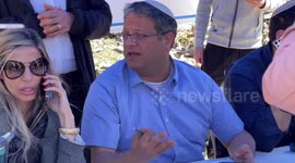 Israeli lawmaker Itamar Ben Gvir sits at table in Sheikh Jarrah, East Jerusalem