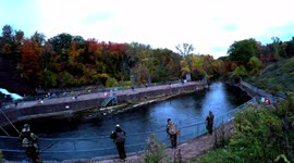 Fisherman's fishing for salmon and troutsat Oak Orchard in October with foliage colors near dam