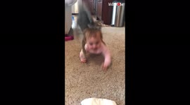 Mischievous cat bodyslams baby girl ruining cute mother-daughter moment