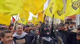 Mourners and militants carry the body of Palestinian teenager killed in Israeli raid