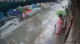 Woman slips and falls into basket while sweeping outside her home