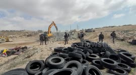 Palestinians protest Israeli machinery demolishing local structure