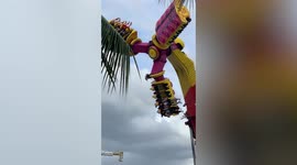 Terrifying moment revellers hang upside down on jammed fairground ride in the Philippines