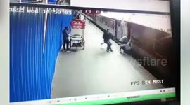 Woman has narrow escape as she is pulled from gap between moving train and platform in India