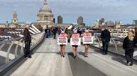 PETA activists stage a catwalk on Millennium Bridge in protest against the use of bird feathers at London Fashion Week