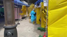 A medical worker treat patients outside as Hong Kong hit with spike in COVID-19 cases