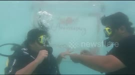 Watch - Husband surprises his wife by celebrating their first marriage anniversary underwater on valentines day . he gifts her a ring underwater