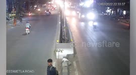 Oblivious pedestrian runs into biker amid road in southern India