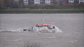 Two tugs, one towing barges, battle the waves on the River Thames during Storm Eunice 18th February 2022