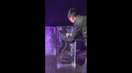 Vietnamese man uses a chainsaw and chisel to sculpt the beautiful swan out of ice