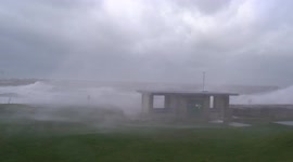 Storm watchers in Rhyl, Wales forced to retreat after being soaked by massive waves from Storm Eunice