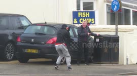 Determined locals fail to walk against Storm Eunice's strong winds in Cornwall
