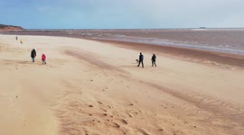Storm Eunice batters Exmouth beach but the sun is shining and people make the most of a deserted beach