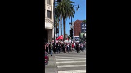 Protesters against masks vaccines and President Joe Biden March down Hollywood Boulevard spreading their views to the tourists and people of Los Angeles CA.