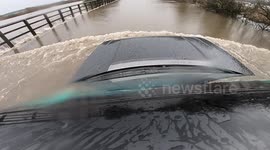Car's-eye view of driving through flooded roads in West Yorkshire during UK's Storm Franklin