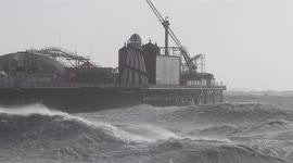 Huge waves lash Palace Pier in Brighton on England's south coast as Storm Eunice hits