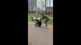 Amsterdam residents use skateboard and bag to make most of Storm Eunice winds