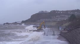 Huge waves from Storm Franklin smash into sea defence works and excavator in northern Wales