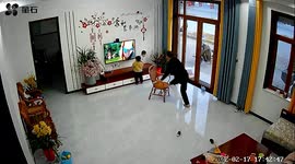 Elderly man with plastered leg catches grandson falling off TV stand in China