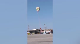 Giant helium balloon crash lands on PLANE at airport in Brazil