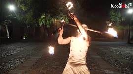 Fire artist showcases daring performance involving spinning flames around his head