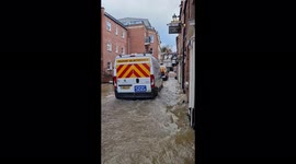 Vans battle through floodwater caused by Storm Franklin in Shrewsbury, Shropshire, UK
