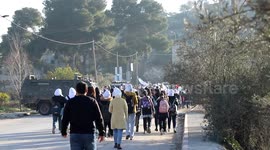 Palestinian students walk to their schools from the main road in al-Lubban al-Sharqiya village, south of Nablus city, in the West Bank