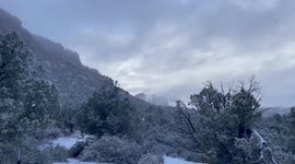 The sky peaks out behind the Beautiful Snow Covered Buttes in the Sedona Arizona Valley