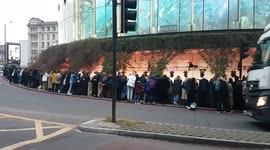 Batman fans desperate for a glimpse of the stars wait on a roundabout in London's Waterloo
