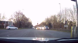 Dashcam - Impatient Driver drives on WRONG side of road to bypass RED Light, into oncoming traffic!