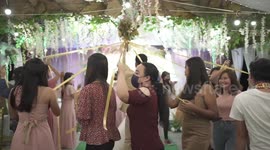 Bride swaps traditional bouquet toss for hilarious musical chairs Maypole dance style game