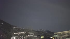 SpaceX Starlink satellite train emerges from behind Swiss mountain