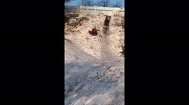 Unsuccessful descent from a snow slide on a cheesecake with a dog