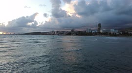 Kitesurf at sunset. The wind blows on the waves of the sea. Cyprus.