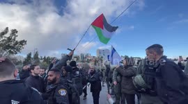 Protesters wave Palestinian flags during a protest in the flashpoint neighbourhood of Sheikh Jarrah in east Jerusalem