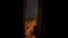 Intense footage on Kyiv balcony overhearing gunfight on street below and capital aflame