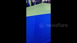 Supporters unfurl a huge National Ukrainian flag during anti-war rally in Oslo, Norway