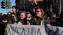 Ukrainian and Russian people express their disagreement during protest against war in Milan