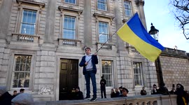 Boy waves Ukraine flag at anti-war protest at Downing Street in London