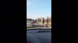 Ukrainians flee across Polish border on foot as Russia invades