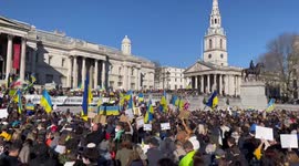 Hundreds of people gather to Stand with Ukraine , Trafalgar Square London . The crowds sings the Ukrainian national anthem to show solidarity with the Ukrainian people .
