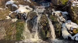 A peaceful waterfall in cold February in Mill Pond park in Newington Connecticut