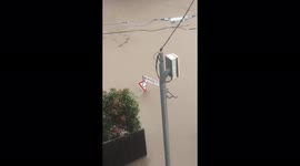 Street sign submerged as deadly floods hit Brisbane, Australia