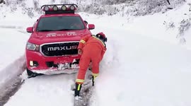 Firefighters clear deep snow to allow vehicles to collect pregnant women in China