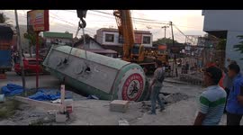 Shocking moment Indonesian cement truck, with driver inside, crashes back into hole