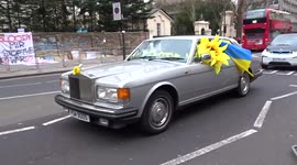 Pro-Ukraine rally outside the Embassy of Russia in London gets support from a fancy car blowing horn